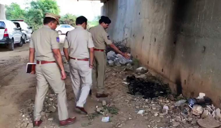 Police officers inspect the site where they found the burned body of a 27-year-old veterinary doctor in Hyderabad | Video grab/AP