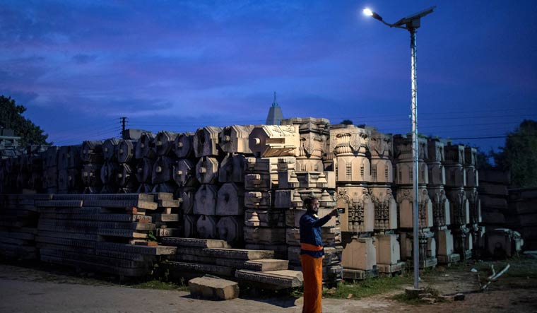 A devotee takes selfie with the pillars that Hindu activists say will be used to build the Ram temple, in Ayodhya | Reuters