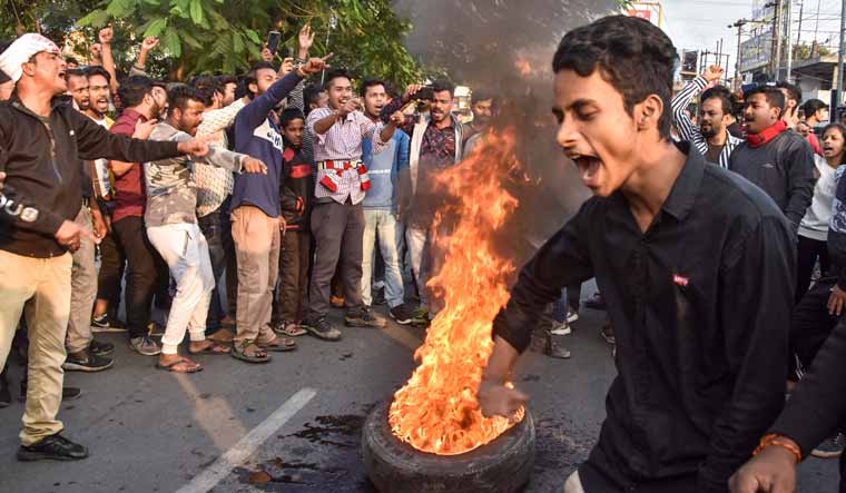 Demonstrators burn tyres during a strike called by All Assam Students Union (AASU) and the North East Students Organisation (NESO) in protest against the Citizenship Amendment Bill, in Guwahati | PTI