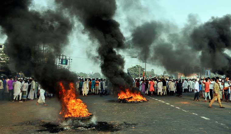Protesters burn tyres during a demonstration against CAB and NRC in Howrah | PTI