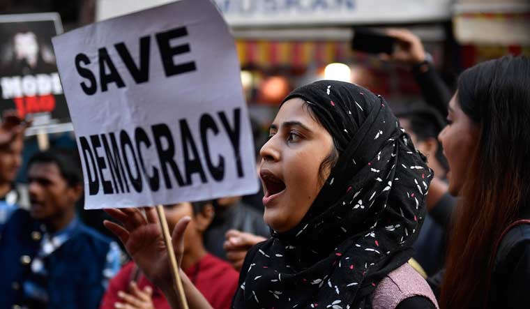A protester holds 'save democracy' placard at a rally in Kolkata | Salil Bera