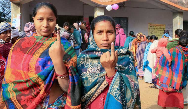 Voters display their fingers marked with indelible ink after casting their votes during the fifth phase of the Jharkhand Assembly elections, in Godda district | PTI