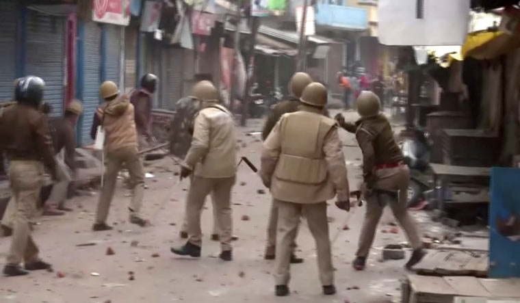 police-throw-stones-protesters-UP-ANI-Reuters
