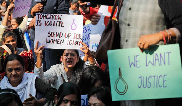 Women activists hold banners and shout slogans during a protest in New Delhi against the gangrape and murder of a veterinarian in Hyderabad | AP