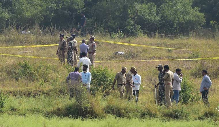 Policemen stand guard the area where four accused in the rape-and-murder case of a 25-year-old woman veterinarian were shot dead by police in Hyderabad | PTI
