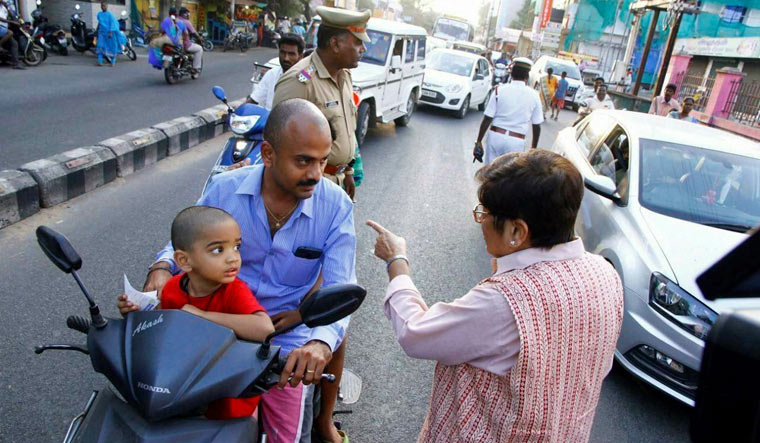  Lt Governor of Puducherry Kiran Bedi instructing a motorcyclist to use helmet | PTI