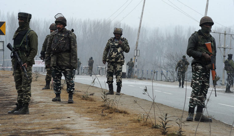 Security forces stand guard along the Jammu-Srinagar highway in Lethpora area in the town of Pampore | AFP