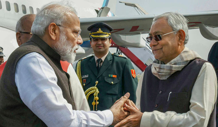 Prime Minister Narendra Modi being greeted by Bihar Chief Minister Nitish Kumar on his arrival at Jai Prakash Narayan airport, in Patna | PTI