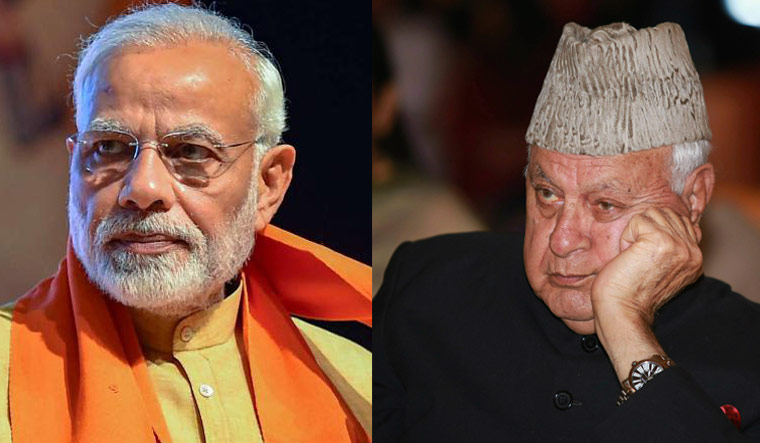 Prime Minister Narendra Modi (L) and National Conference president Farooq Abdullah