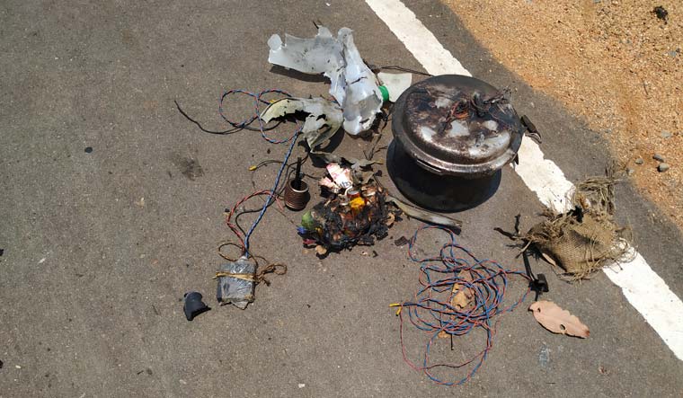 On a recently tarred road, the charred remains of a pressure cooker, a battery, some wires and metallic implements and the remains a petrol can were starkly visible | Sravani Sarkar
