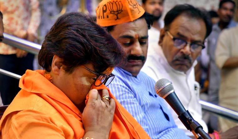 BJP candidate Sadhvi Pragya Singh Thakur reacts while addressing a party workers' meeting for Lok Sabha polls, in Bhopal | PTI