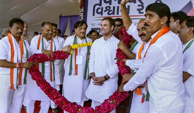Congress president Rahul Gandhi being garlanded at an election campaign rally for the general elections in Bajipura village of Tapi district of Gujarat, Friday | PTI