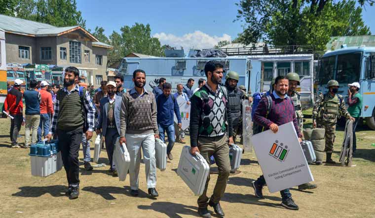 People on election duty carry equipment for the Lok Sabha poll in Anantnag | PTI