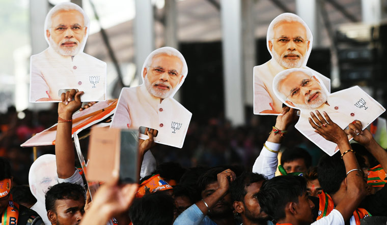 Supporters hold cut outs of Narendra Modi during a rally at Kolkata's Brigade Ground | Salil Bera