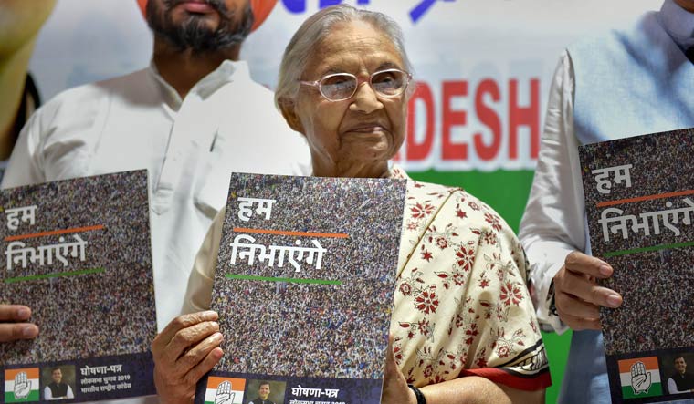 Delhi Pradesh Congress Committee president Sheila Dikshit displays a copy of party's manifesto for the upcoming Lok Sabha elections at a press conference at DPCC office in New Delhi | PTI