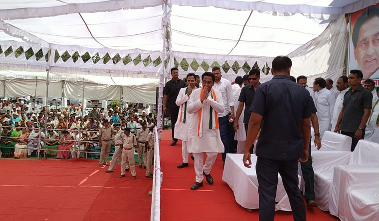 Kamal Nath and Nakul Nath arrive on stage to address a rally after filing nominations