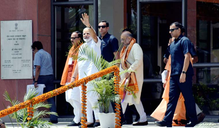 Prime Minister Narendra Modi waves as he leaves Trade Facilitation Center along with BJP president Amit Shah, in Varanasi | PTI