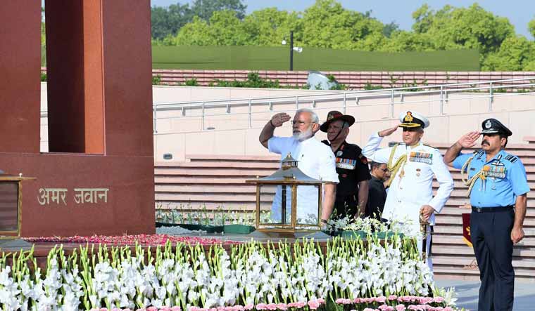 Prime Minister Narendra Modi saluting military personnel who died in the line of duty | Twitter handle of Narendra Modi