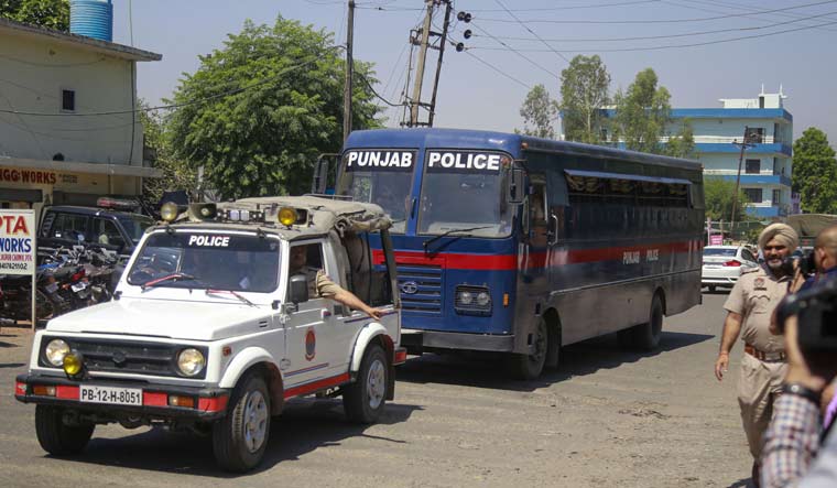 A police bus carrying the accused in the rape and murder of a nomadic minor girl in Jammu and Kashmir's Kathua, arrives at the Judicial Courts Complex for the verdict, in Pathankot | PTI
