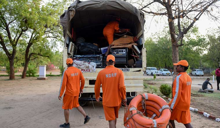 NDRF personnel load life saving material on a truck in Chiloda, some 40 kms from Ahmedabad | AFP