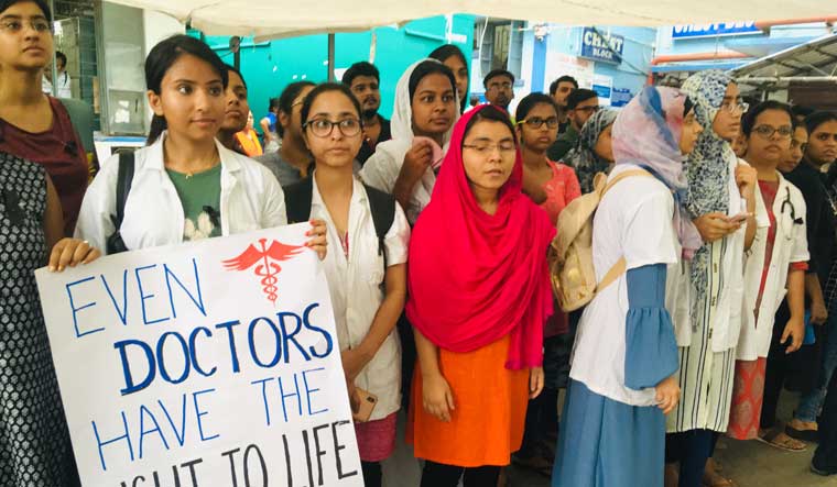 Doctors hold placards during their strike in protest against an attack on an intern doctor, in Kolkata | Salil Bera