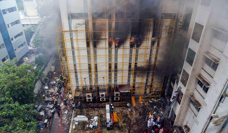 Fire fighters douse a fire that broke out at MTNL office building at Bandra, in Mumbai | PTI