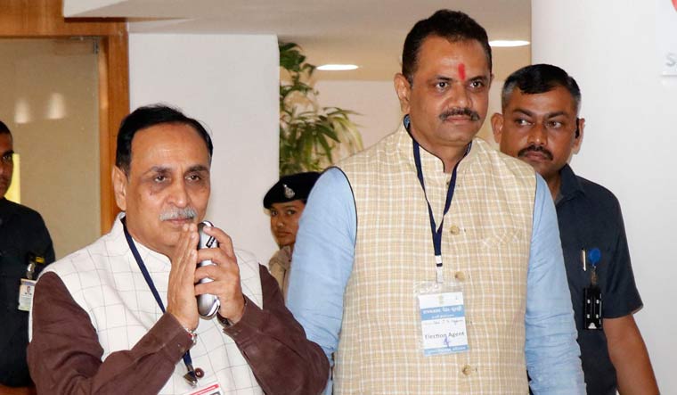 Gujarat Chief Minister Vijay Rupani and state BJP president Jitu Vaghani coming out from the voting centre after casting their votes in Rajya Sabha election | PTI