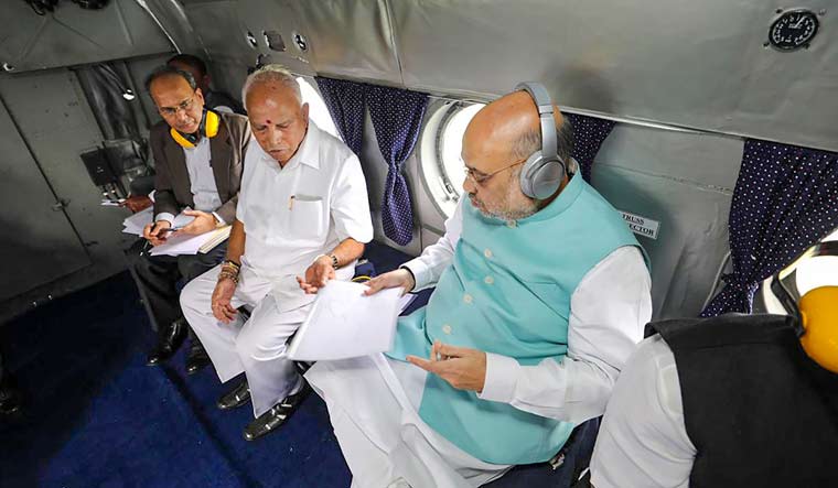 Union Home Minister Amit Shah and Karnataka Chief Minister B.S. Yediyurappa undertake aerial survey to review the food situation in Belagavi district | PTI