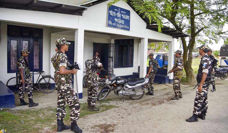Security personnel stand guard outside an NRC centre at Rupohi village in Nagaon | PTI