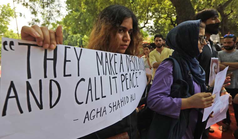 Kashmiris residing in Delhi and supporters take out a silent protest against the  government revoking Kashmir's special constitutional status | AP