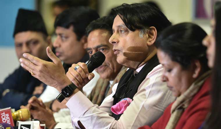Congress MP Shashi Tharoor speaks at a press conference as Delhi Pradesh Congress Committee president Subhash Chopra looks on, during the launch of Delhi Congress campaign to crowdsource ideas and suggestions from the people | PTI