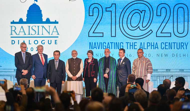 Prime Minister Narendra Modi in a group photo with the delegates during the inaugural session of Raisina Dialogue 2020, in New Delhi | PTI