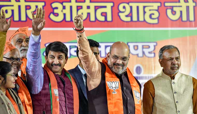 Union Home Minister Amit Shah (2nd R) with Delhi BJP President Manoj Tiwari (2nd L) during a Nukkad Sabha for the Delhi polls at Mustafabad in New Delhi | PTI