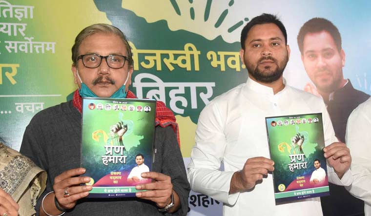 RJD leader Tejashwi Yadav, along with party MP Manoj Jha and others, releases party's manifesto 'Prann Hamara', ahead of the Bihar Assembly elections, at party office in Patna | PTI