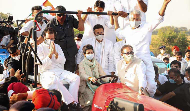 Senior Congress leader Rahul Gandhi along with party general secretary Randeep Singh Surjewala rides a tractor driven by party's Haryana president Kumari Selja during a protest against the new farm bills | PTI