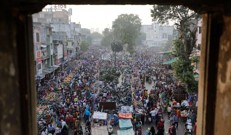[File] People throng a market for shopping ahead of Hindu festival Diwali in Ahmedabad on November 12 | AP