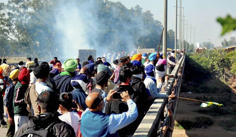 Tear gas being fired by police on members of various farmer organizations during their 'Delhi Chalo' protest march, at Shambu border in Patiala | PTI