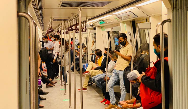 Commuters wearing face masks travel in a metro train in Delhi | AP