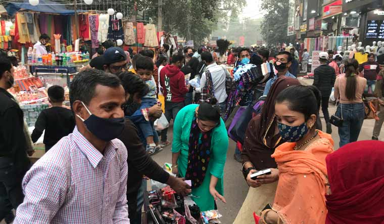 People shop at a roadside stall ahead of Diwali at the Lajpat Nagar market in New Delhi | AP