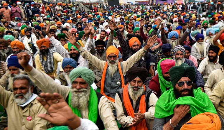 Farmers shout slogans at Singhu border during their 'Delhi Chalo' protest march against the Centre's new farm laws, in New Delhi, in New Delhi | PTI