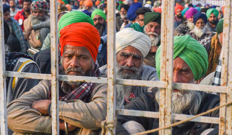 Farmers during a protest against the new farm laws, at Singhu Border in New Delhi | PTI