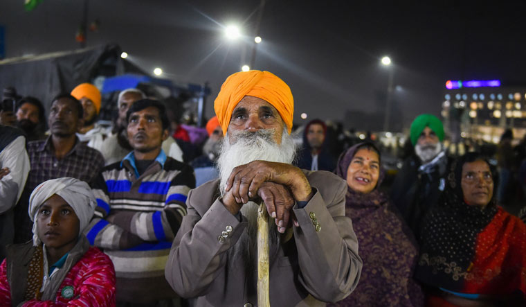 Farmers watch a documentary on the issue of farmers during their protest against the Centre's new farm laws, at Ghazipur border in New Delhi | PTI