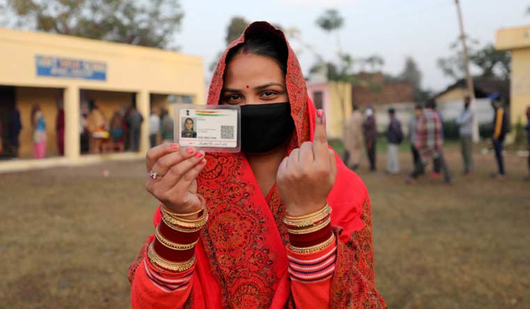 A West Pakistani refugee shows her finger marked with indelible ink after casting her vote for the third phase of DDC election, at Chak Jafar village in Jammu | PTI