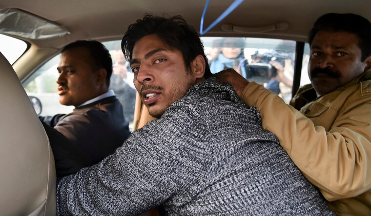 Police take away an unidentified person after he allegedly opened fire in the Shaheen Bagh area of New Delhi | PTI