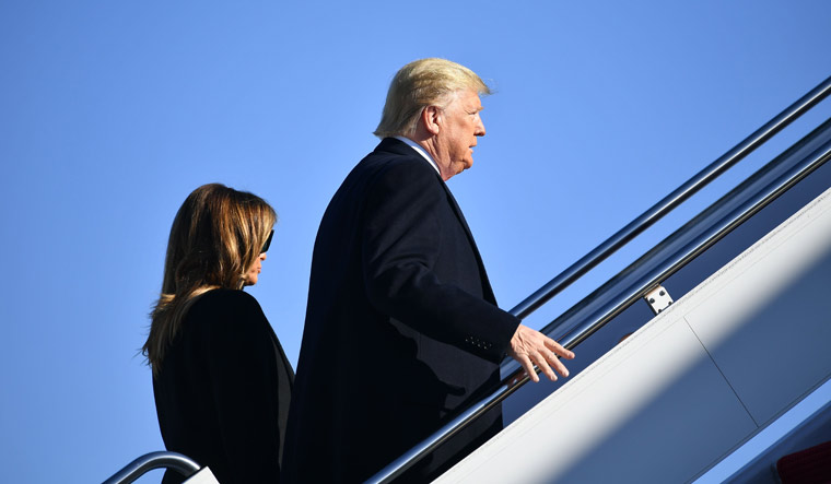 US President Donald Trump and First Lady Melania Trump make their way to board Air Force One before departing from Andrews Air Force Base in Maryland | AFP