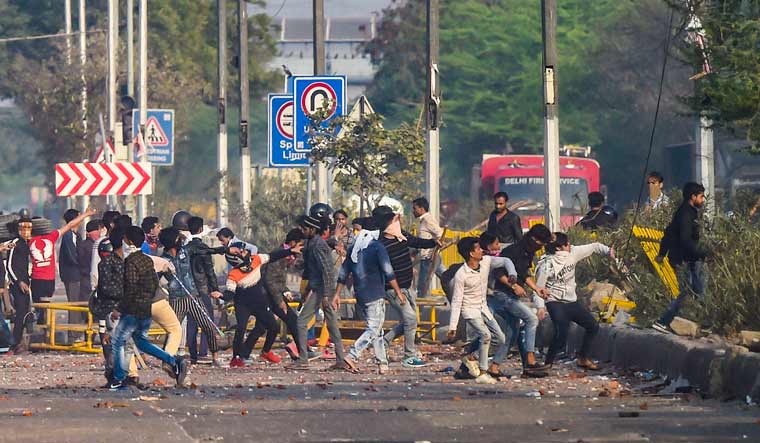 Rioters pelt stones during clashes between those against and those supporting the Citizenship (Amendment) Act in north east Delhi | PTI