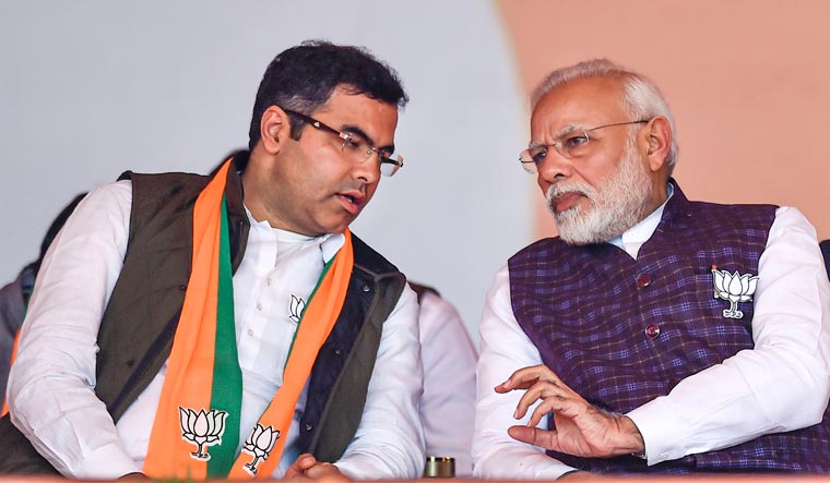 Prime Minister Narendra Modi with BJP West Delhi MP Parvesh Verma (R) during an election campaign rally at Dwarka | PTI