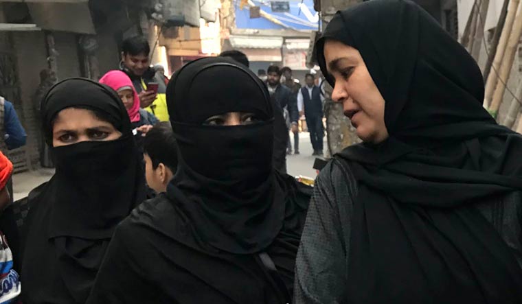 Muslim women arrive to cast their votes at Shaheen Public School | AP