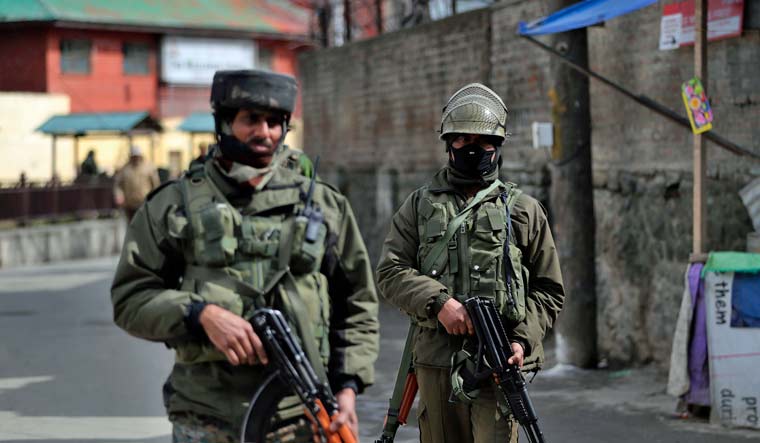 Indian paramilitary soldiers guard at a market in Srinagar, Indian controlled Kashmir | AP