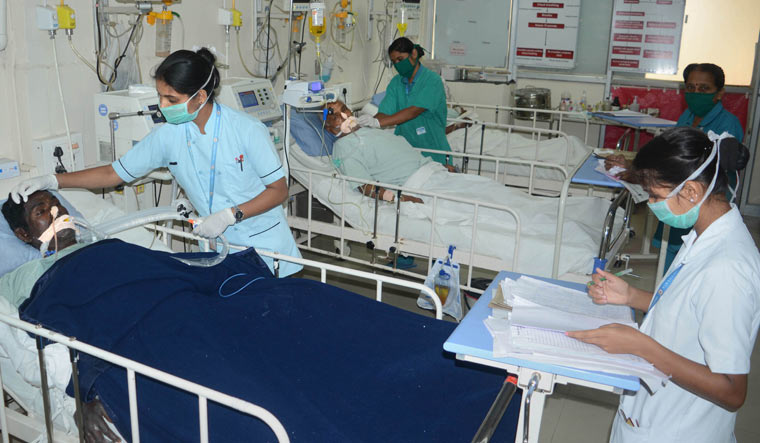 Nurses wearing protective masks treat patients at a hospital in Karad | PTI